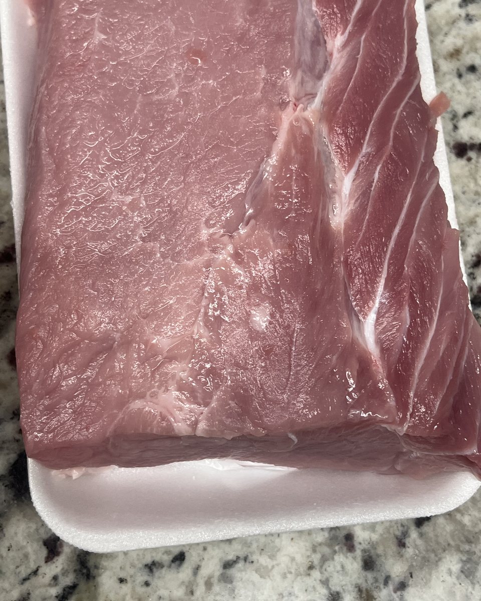 A trimmed boneless pork loin sitting in a tray